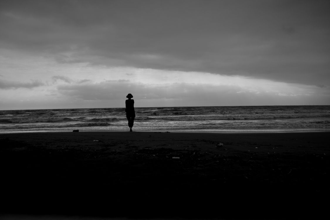 Silhouette of person standing tall alone